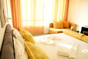 Postel nebo postele na pokoji v ubytování Hotel Paradise