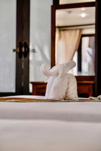 a stuffed bunny sitting on top of a bed at Kooncharaburi Resort - Koh Chang in Ko Chang