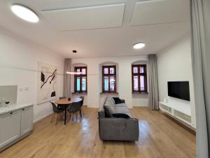 a living room with a couch and a table at Apartament Sztolnia in Kowary