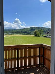 een balkon met uitzicht op een veld bij Danner Familien-Ferienwohnungen Schörfling am Attersee in Schörfling