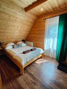 a bedroom with a bed in a wooden room at U Dziadka in Chochołów