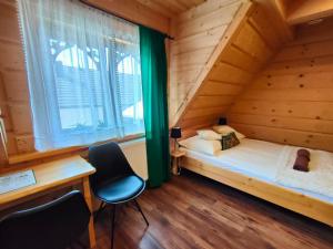 a bedroom with a bed in a wooden house at U Dziadka in Chochołów