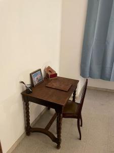 a wooden table with a picture and a box on it at Charmant logement proche de la mer in Florensac