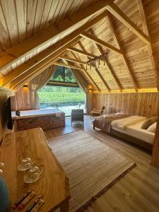 a large room with two beds and a table at Serinle Bungalow in Rize