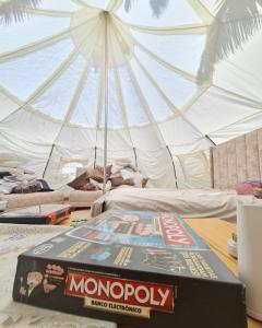 a monopoly box on a table in front of a tent at Hermoso Glamping en Quinta Privada in Quito
