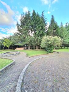 a walkway in a park with trees and grass at Hermoso Glamping en Quinta Privada in Quito