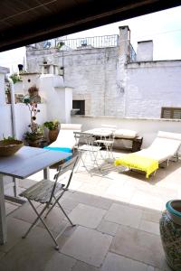 a patio with a table and chairs on a roof at Nel Vico Antico in Ostuni