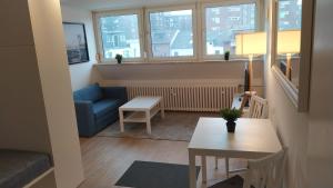 a small living room with a table and a couch at Frisch renoviertes Appartement in Mönchengladbach