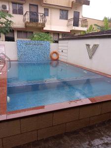 a large swimming pool in front of a building at Treebo Trend Five Elements Lonavala in Lonavala