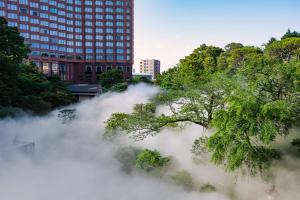 a pile of fog in front of a tall building at Hotel Chinzanso Tokyo in Tokyo