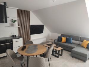 a living room with a couch and a table at Luksusowy Apartament EDITH Giżycko in Giżycko