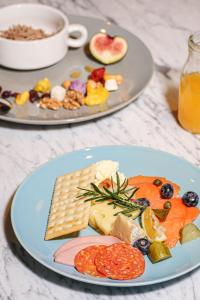 two plates of different types of food on a table at Sheraton Nanjing Kingsley Hotel & Towers in Nanjing