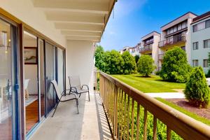 a balcony with a chair and a view of a yard at Tiburon 2C in Ocean City