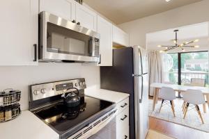 a kitchen with a stove and a microwave at Tiburon 2C in Ocean City