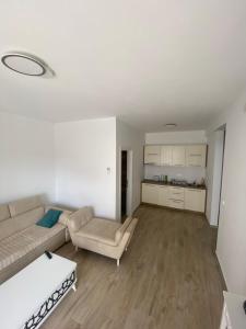 a living room with a couch and a table at Emma Lux Apartment in Dobra Voda