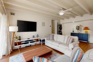 a living room with a couch and a flat screen tv at Tiburon 2C in Ocean City