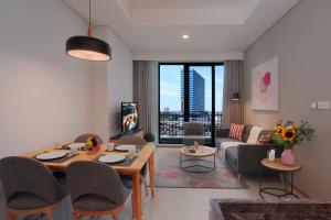 a living room with a table and a couch at Citadines Gatot Subroto Jakarta in Jakarta