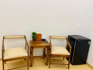 a dining room with a table and a television at Romo Homestay in Quang Ngai