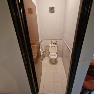 een kleine badkamer met een toilet in een stal bij appartement les Jardins de la Moulouya in Saidia 