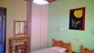 a bedroom with a bed and a mirror at Rose Garden 2 in Kavos