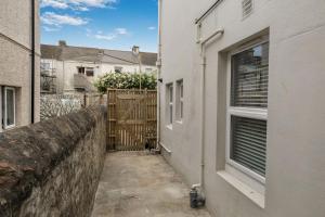a small alley between two buildings with a window at NEW Stunning Plymouth Central Apartment - Sleeps 6 in Plymouth