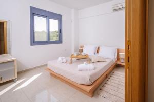 A bed or beds in a room at Olea Seaside luxury apartment in Crete
