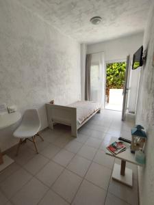 a bedroom with a bed and a table and a window at Ble Island in Hersonissos