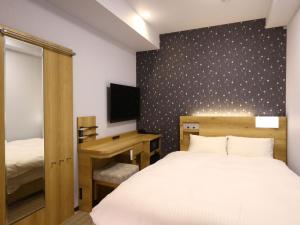 Postel nebo postele na pokoji v ubytování ホテル B Suites なんば黒門