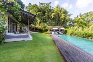 an exterior view of a house with a swimming pool at Villa Artis in Canggu