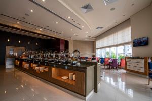 a restaurant with a bar with wine glasses at Novotel Fujairah in Fujairah
