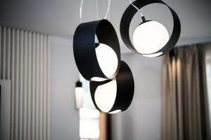 three black and white lights hanging from a ceiling at Luxury Martina apartment in Veliko Tŭrnovo
