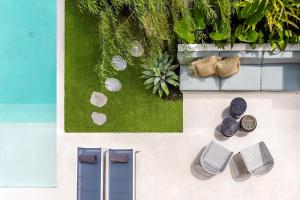an overhead view of a garden with shoes and plants at Casa Umalas Villa by Betterplace in Canggu