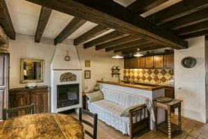 a living room with a table and a fireplace at Castell de Palau Sator in Palau Sator