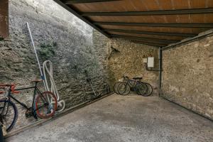 two bikes parked next to a stone wall at Castell de Palau Sator in Palau Sator