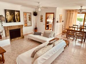 a living room with a couch and a fireplace at Valencia Sol y Playa in Sagunto