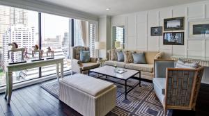 a living room with a couch and a table at Cape House Hotel, Bangkok in Bangkok +65 photos