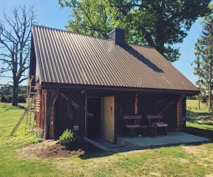 a barn with a table and a bench in it at Liafa laikas 