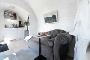 a living room with a couch and a table at Igluhut on the South Coast of Lohusalu 200m from the Sea! in Lohusalu