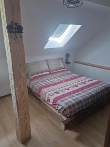 a bed sitting in a room with a skylight at AlBy&B in Arnoldstein