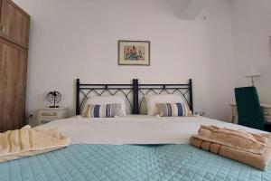 a bedroom with a large bed with a blanket on it at Old Port View Apartment, διαμέρισμα στο κέντρο 2 υπνοδωματίων in Corfu Town