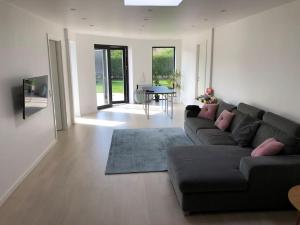 a living room with a couch and a table at House close to the city in Copenhagen