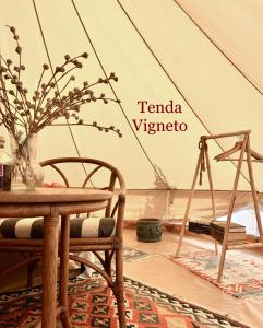 a room with a tent with a table and chairs at Stecadó Glamping in Dolceacqua