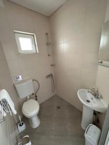 a bathroom with a toilet and a sink at Villa Stefanoski in Konsko