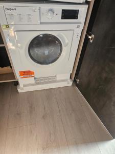 a washing machine sitting inside of a room at Luxury Room in Harold Wood