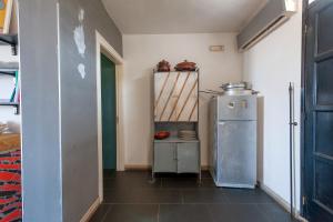 a small kitchen with a refrigerator in a room at Villa Olivia pool tennis spa - C in Lecce