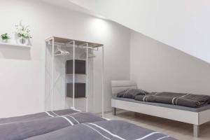 a white room with a bed and a shelf at Top ausgestattet Netflix Wifi Veltins Arena in Gladbeck