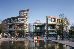 a group of buildings in a city with a water fountain at Top Equipped Netflix WLAN Landschaftspark in Duisburg