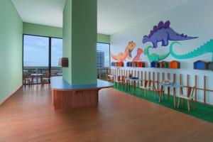a dining room with a dinosaur mural on the wall at Citadines Gatot Subroto Jakarta in Jakarta