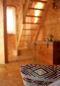 a chair in a room with a wooden ceiling at Ô Bois Dormant in Lempzours