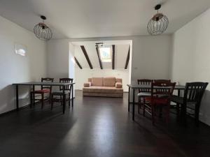 ein Wohnzimmer mit Tischen, Stühlen und einem Sofa in der Unterkunft Hostel Old School in Rijeka